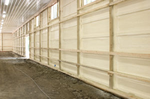 Interior view of white metal walls of a large building.