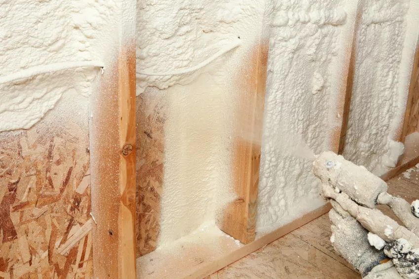 Spray foam being applied to a wall.