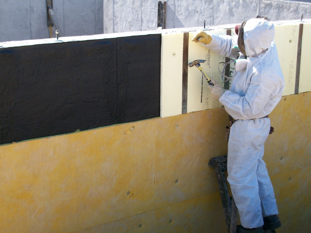 A technician waterproofing a home